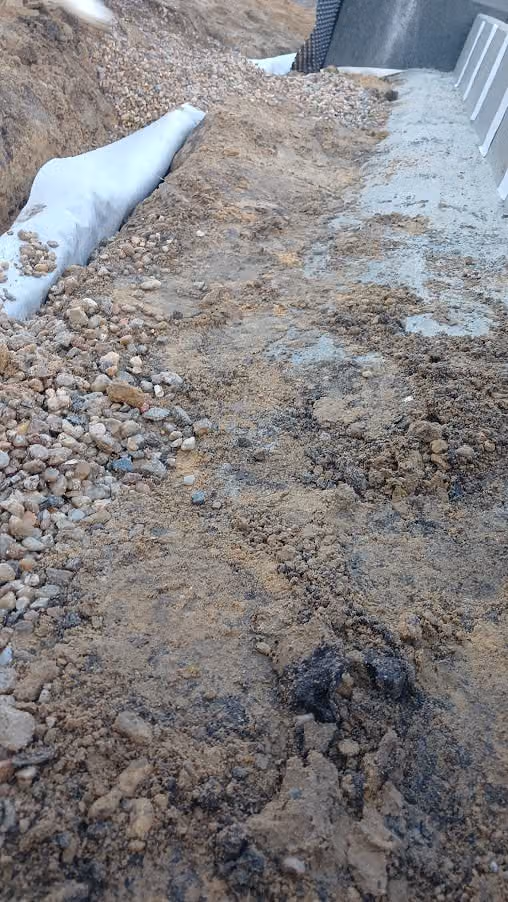 Sohle des Drainagegrabens am Fundament mit eingebautem Filterkies